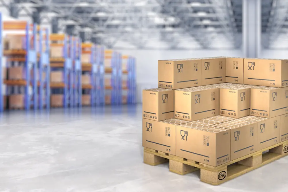 Stacked boxes on a pallet in a warehouse.