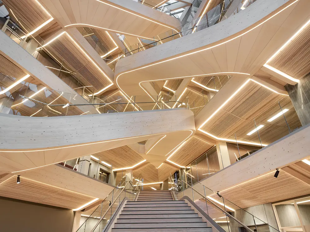 Entrance area with wooden galleries and a staircase in the middle of the picture