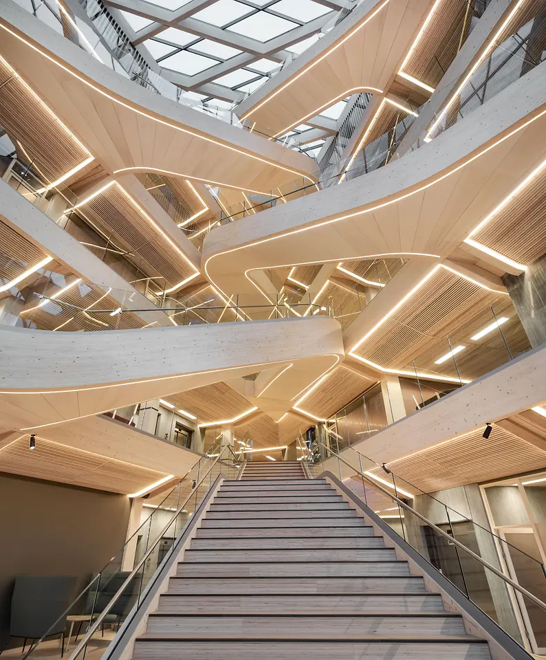 Entrance area with wooden galleries and a staircase in the middle of the picture