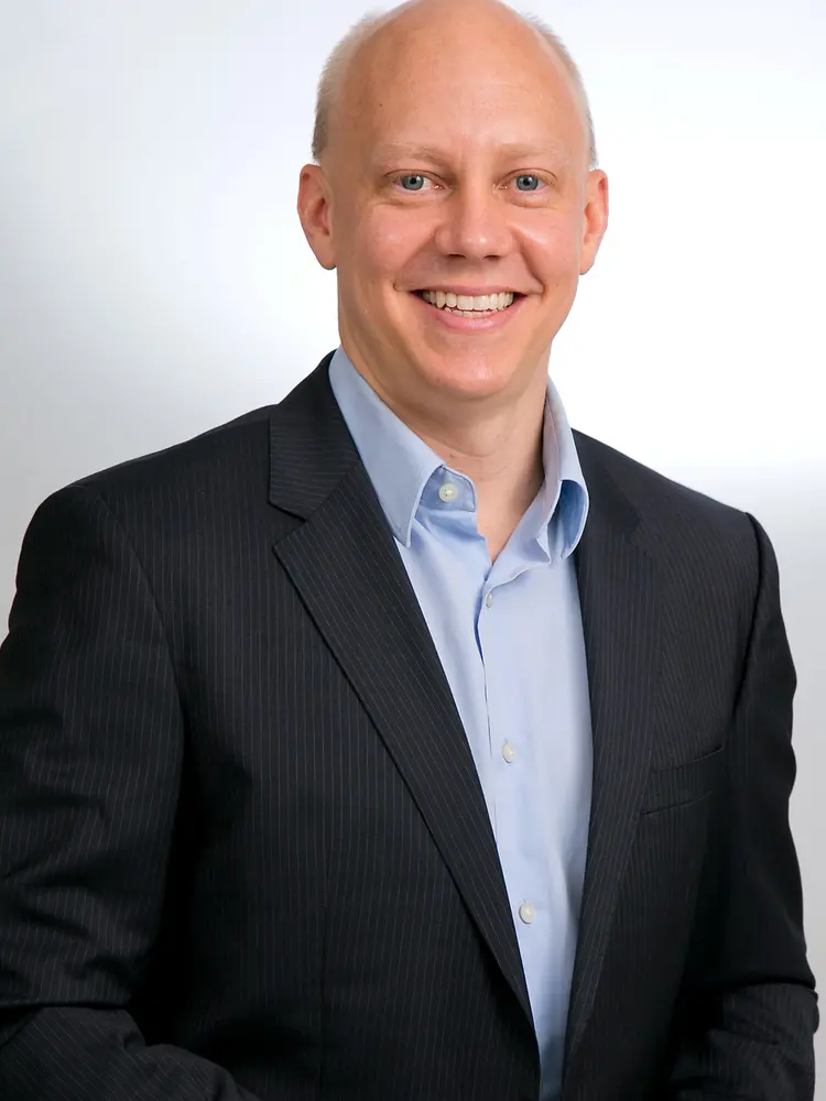 Man in suit smiling at the camera