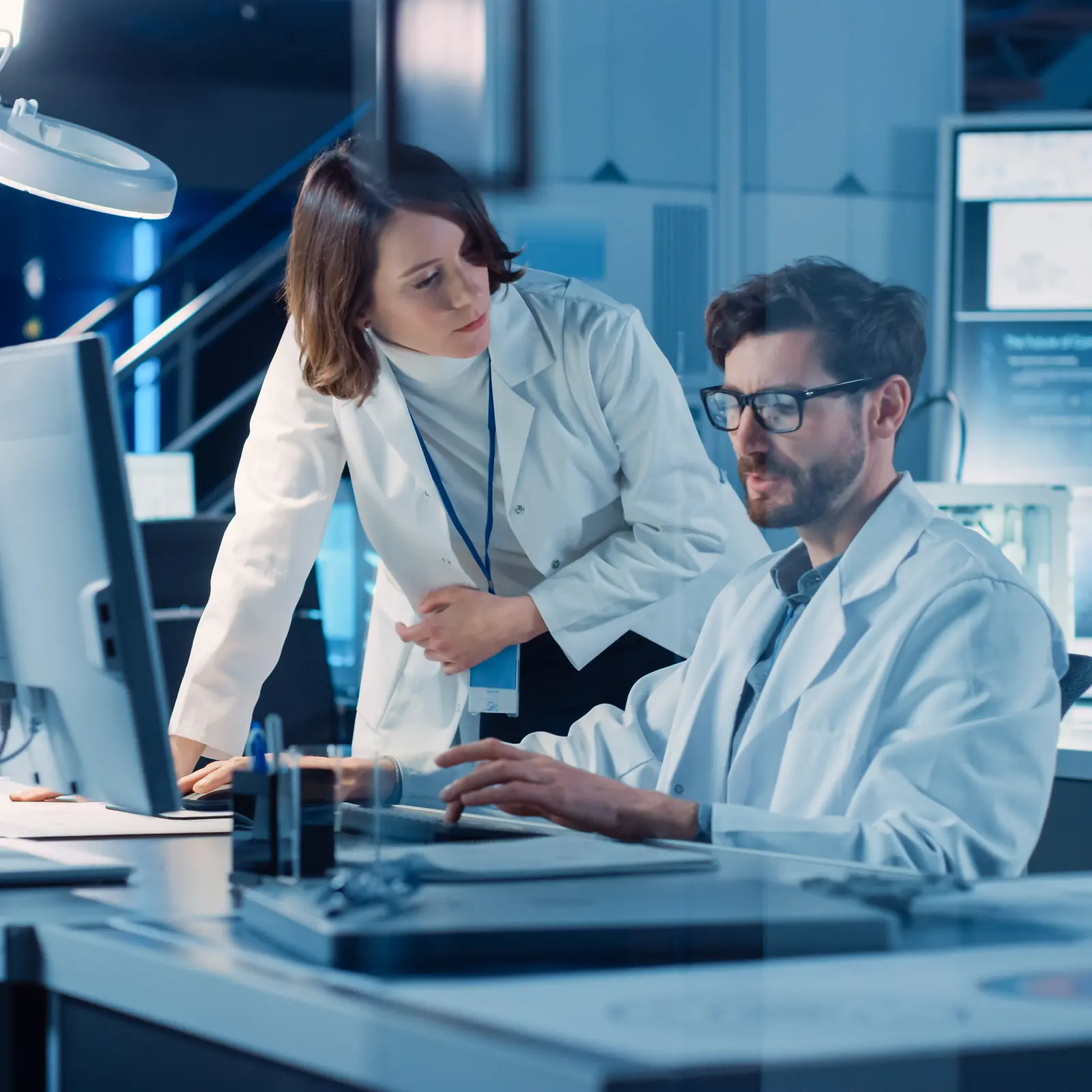 Innovation Partnerships: Man and women in a lab looking at a screen