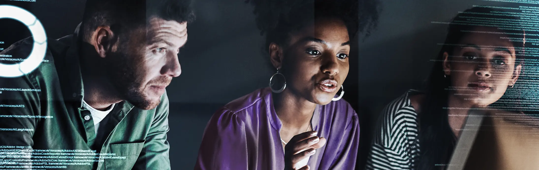 Innovation: young man + 2 young women sitting in front of a desk