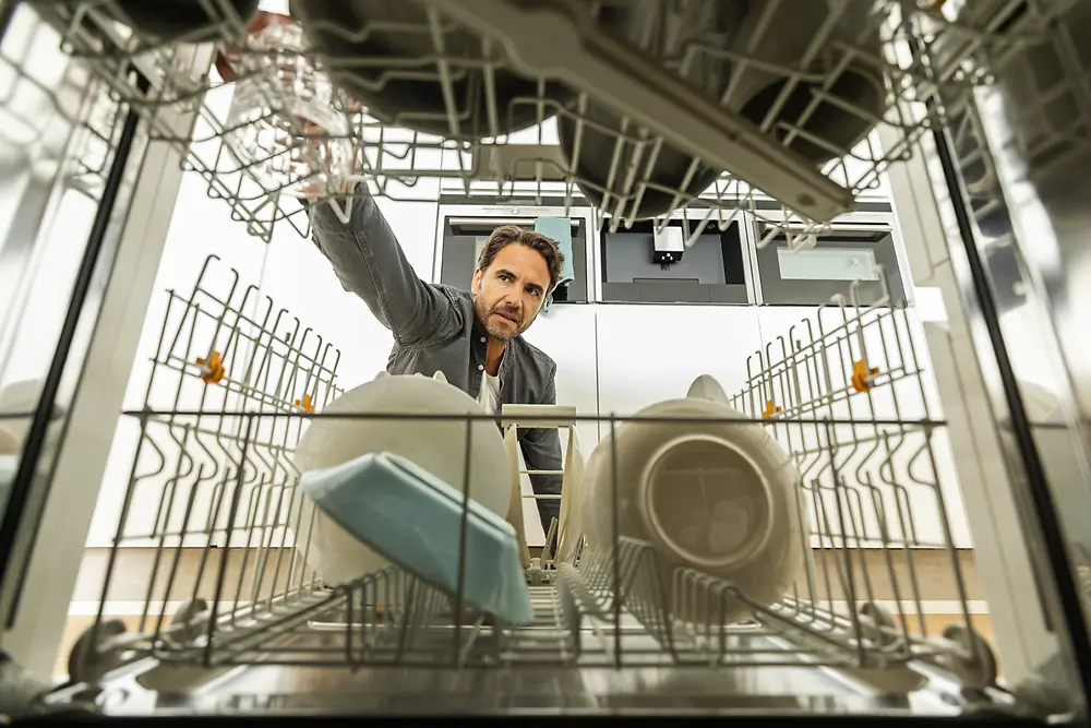 Person loading a dishwasher